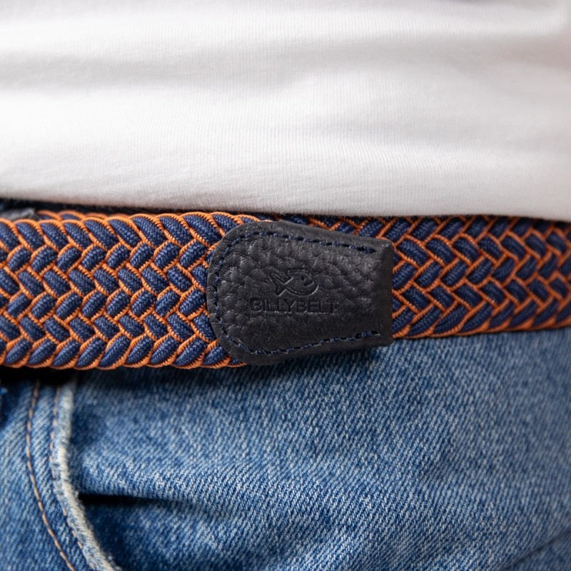 Close-up of a blue and orange belt with a leather buckle worn on jeans.